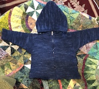 Zipper front baby cardigan with hood.